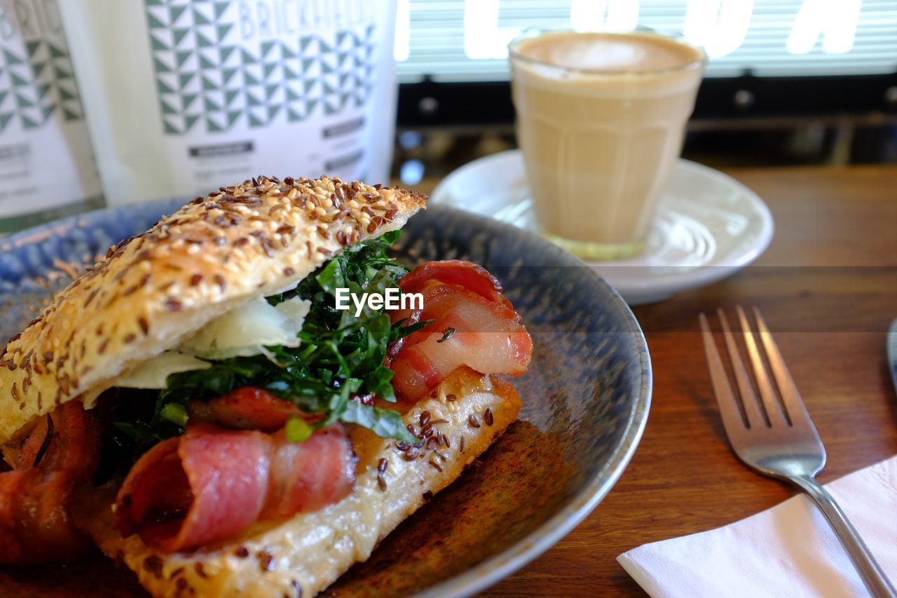 Hamburger and coffee on table