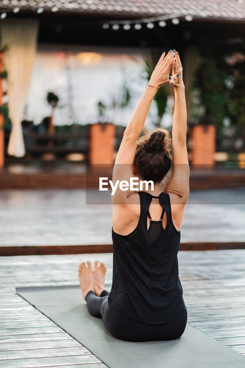 Woman exercising on mat at park