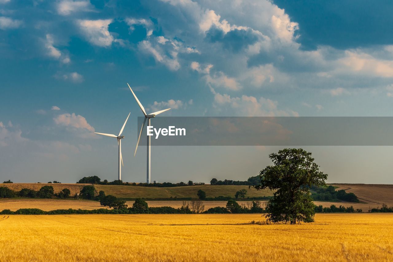 Windmill on field against sky