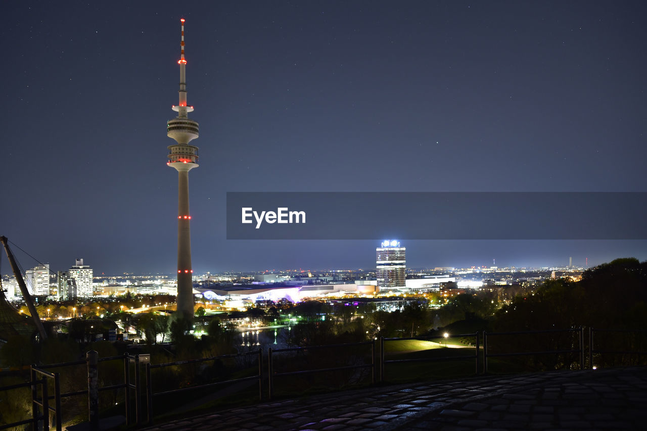 Illuminated olympiatower in city at night