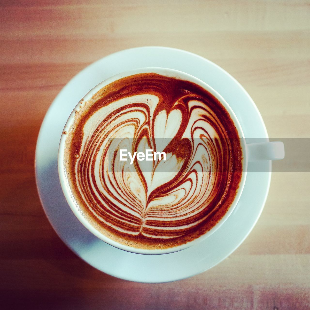 CLOSE-UP OF COFFEE CUP ON TABLE