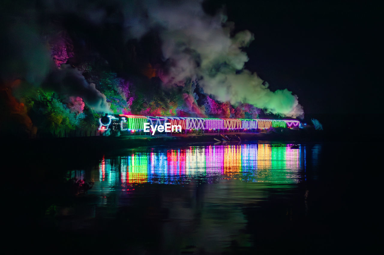 Reflection of illuminated train at night