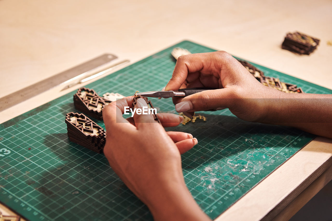 High angle view of woman hand on table