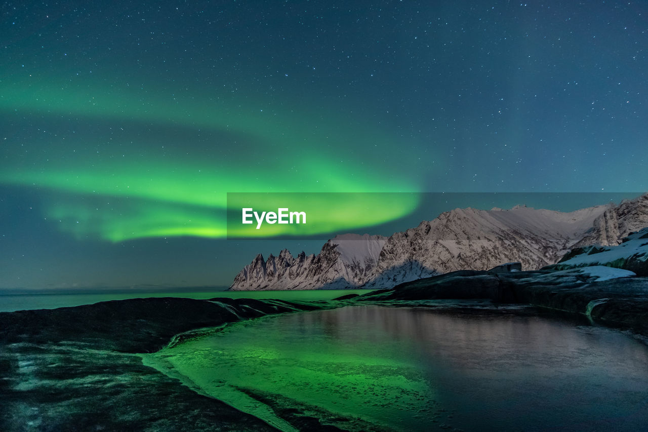 Scenic view of rock formation against sky at night