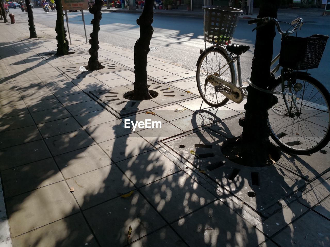 Bicycle parked on sidewalk in city