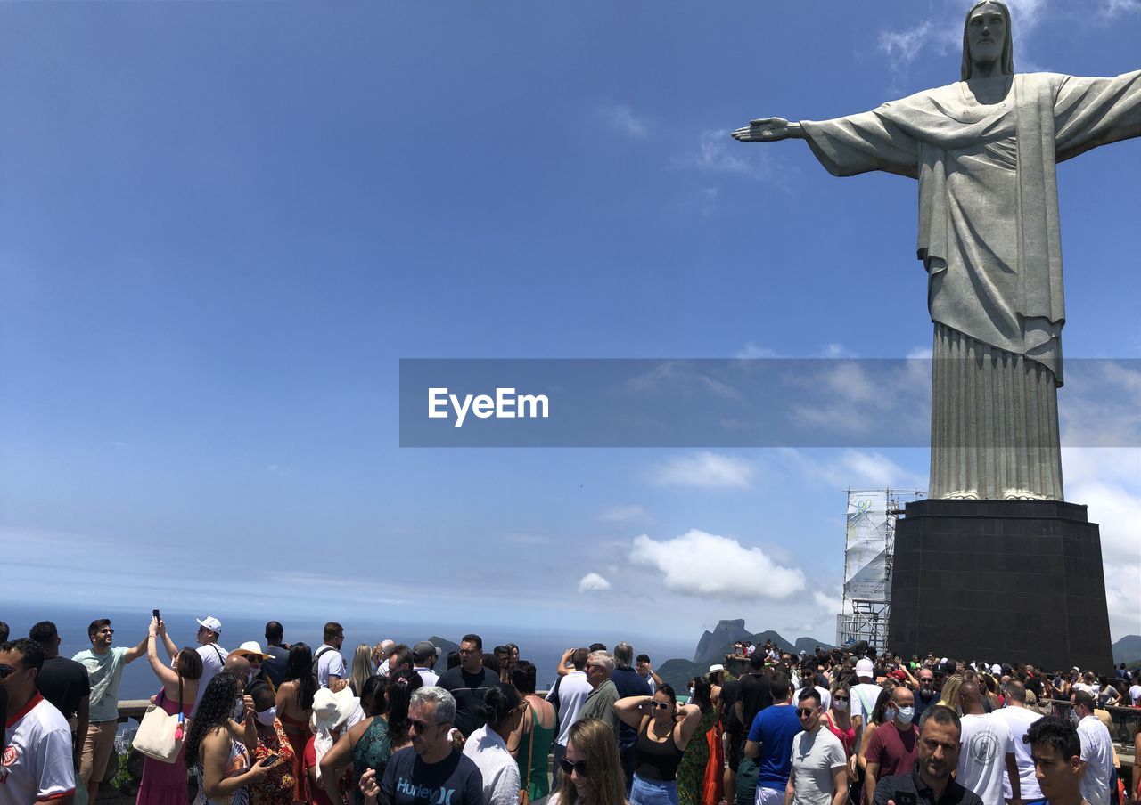 crowd, large group of people, group of people, sky, statue, architecture, sculpture, travel destinations, nature, travel, tourism, person, religion, cloud, monument, day, outdoors, women, human representation, belief, memorial, spirituality, adult