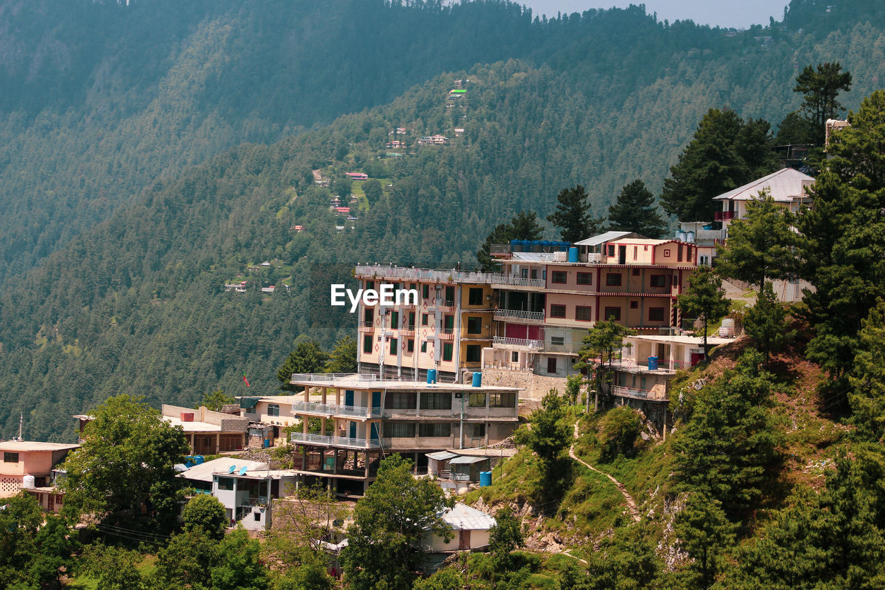 high angle view of townscape by mountain