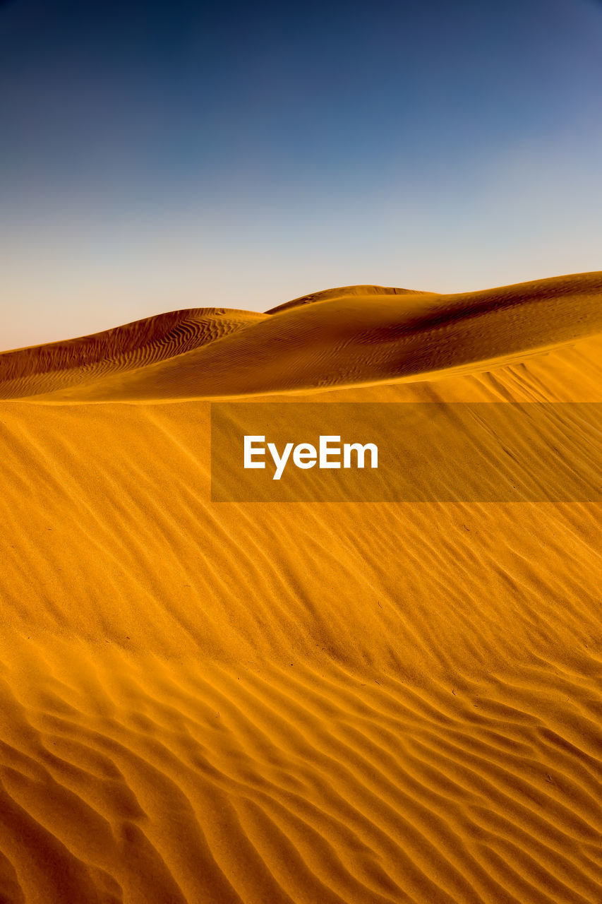 Scenic view of desert against clear sky