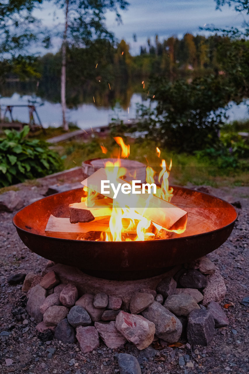 burning, fire, flame, heat, nature, campfire, bonfire, fire pit, tree, leaf, no people, camping, outdoors, glowing, backyard, land, dusk, plant, autumn, sky, day, summer, food and drink, forest, holiday, food, fireplace, water