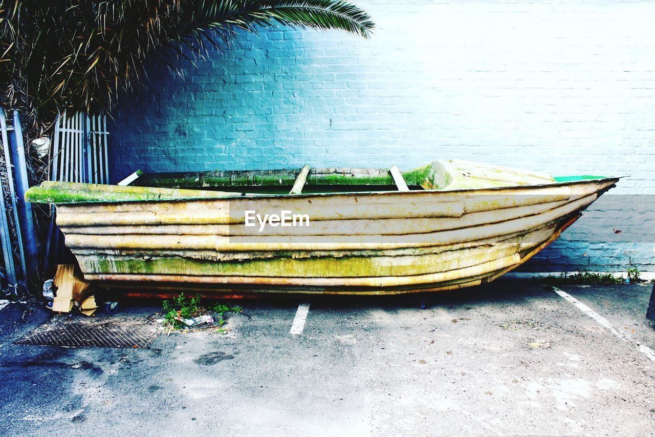 Boat moored against wall