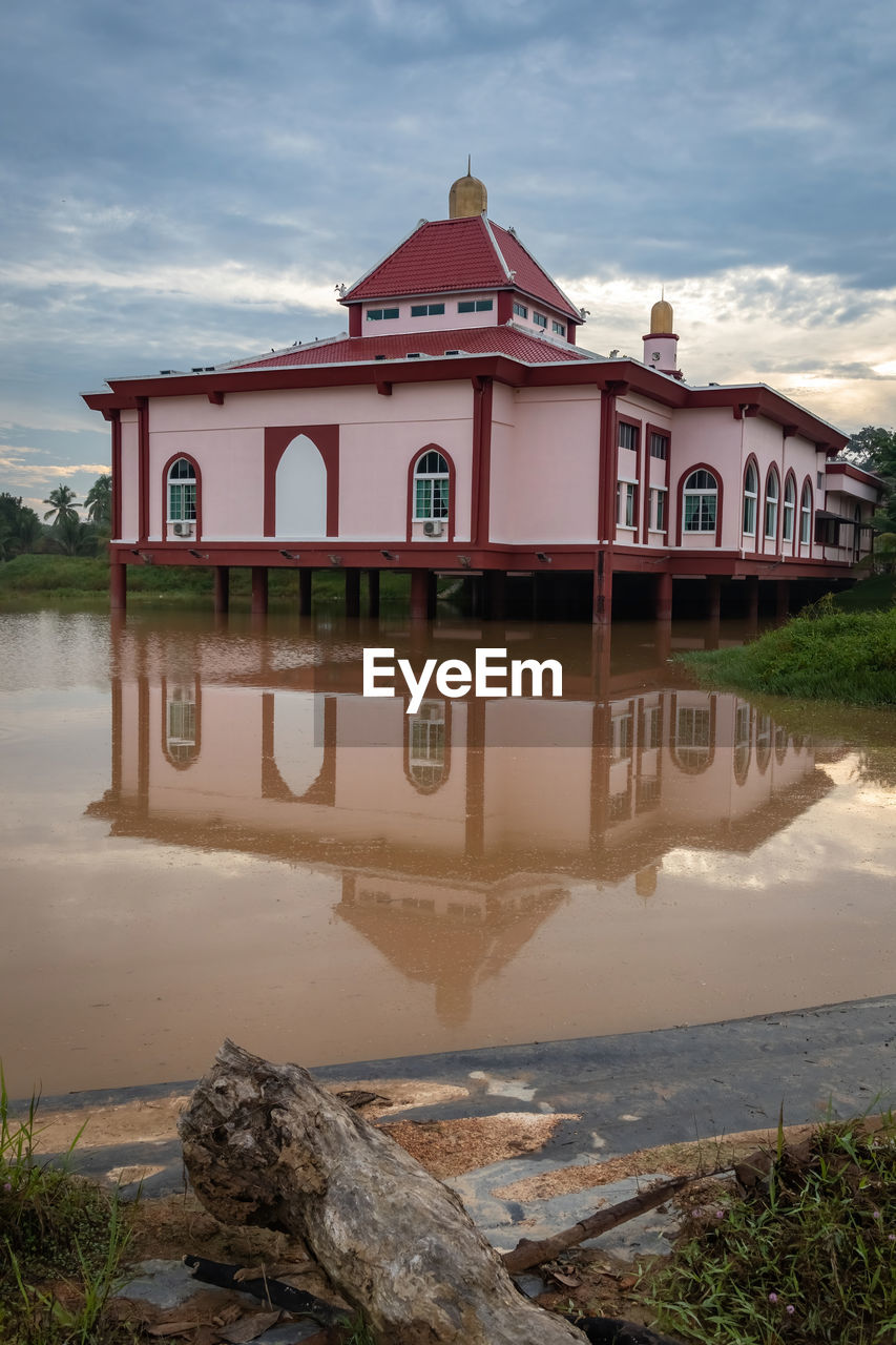 water, architecture, cloud, nature, sky, built structure, building exterior, reflection, lake, building, no people, vacation, travel destinations, house, landscape, land, beach, travel, outdoors, environment, coast, tourism, plant, tranquility, day, estate, beauty in nature, scenics - nature, wood, history