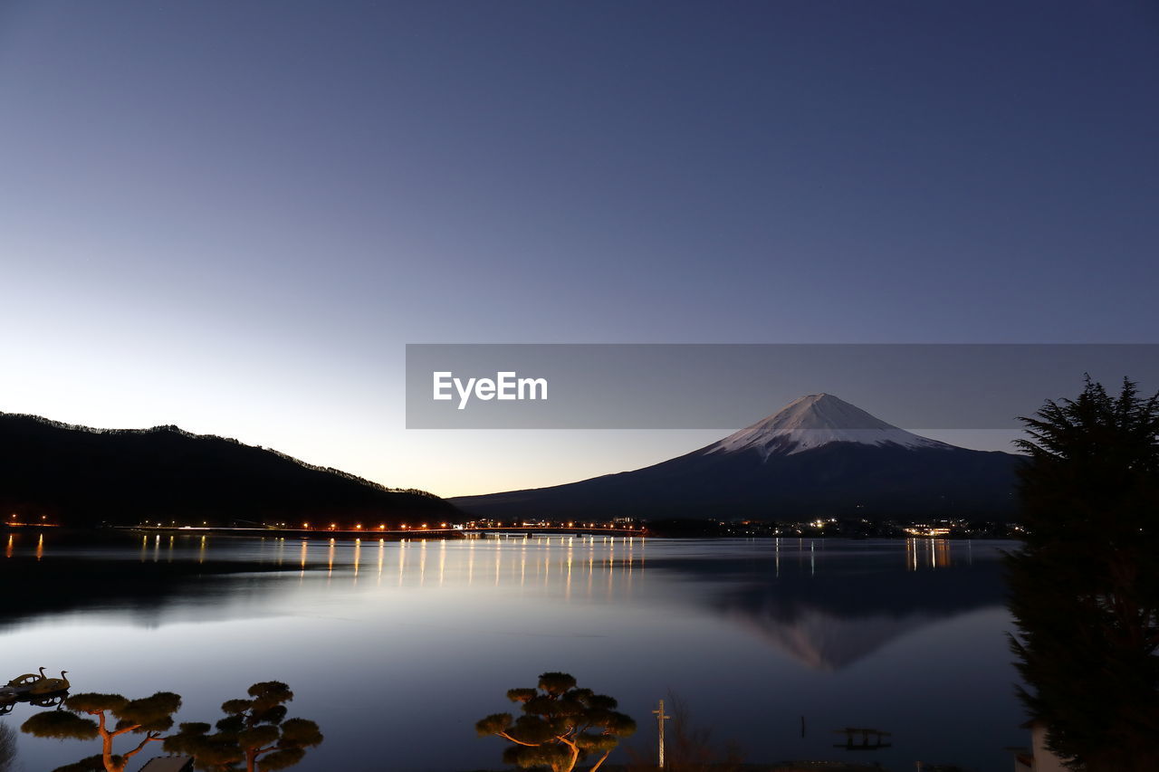 Scenic view of lake against clear blue sky