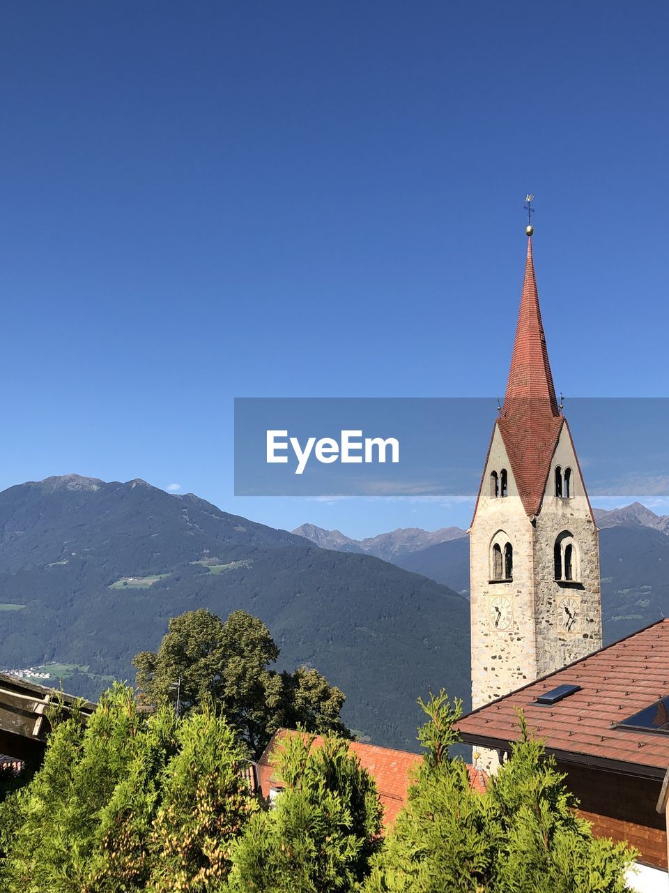 CATHEDRAL BY BUILDINGS AGAINST BLUE SKY