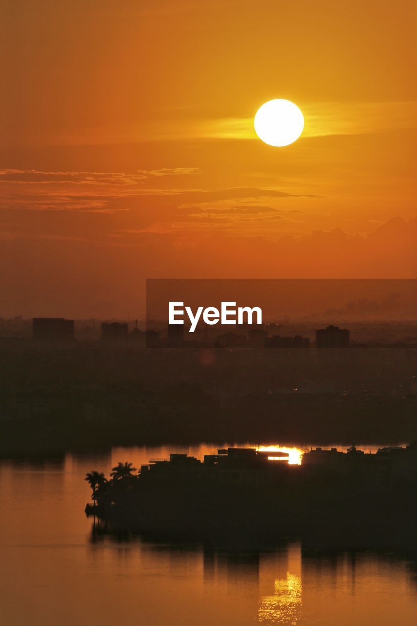 SCENIC VIEW OF SEA AGAINST ORANGE SKY DURING SUNSET