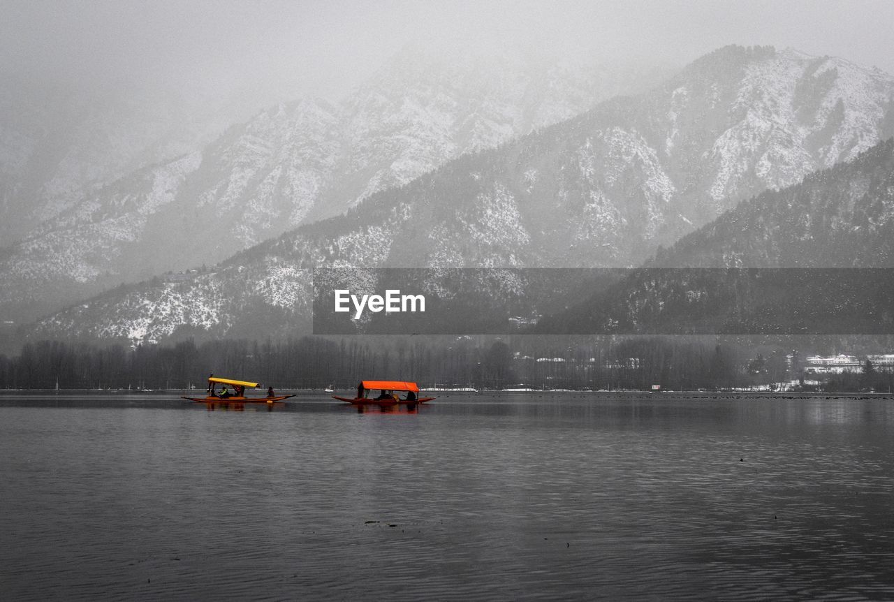 Scenic view of lake against snowcapped mountains