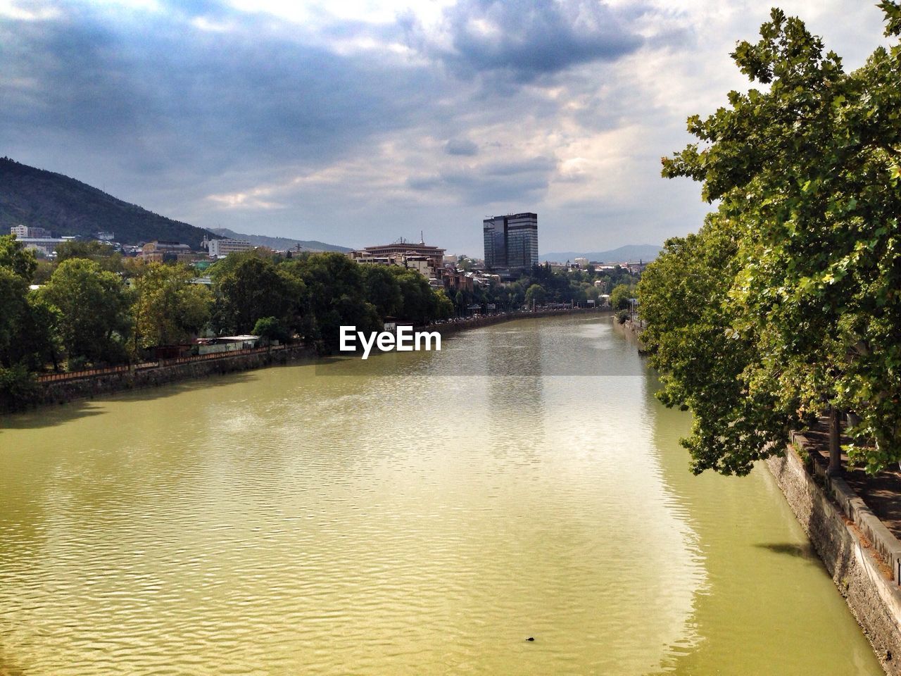 RIVER WITH BUILDINGS IN BACKGROUND