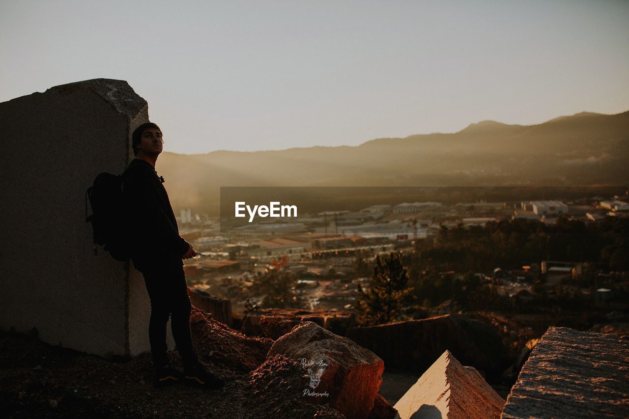 Man standing on mountain against sky