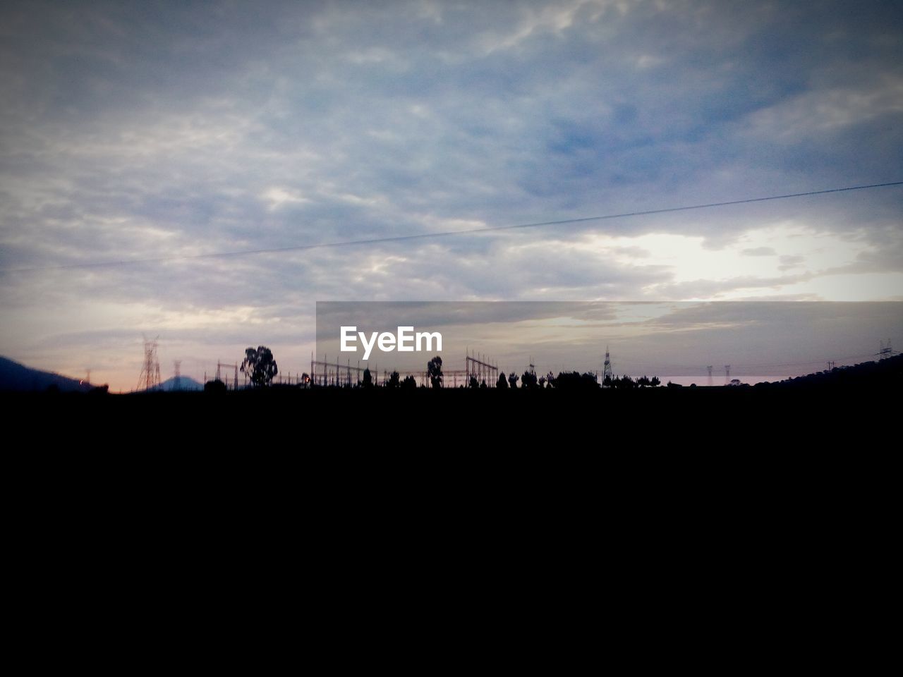 SILHOUETTE OF LANDSCAPE AGAINST SUNSET