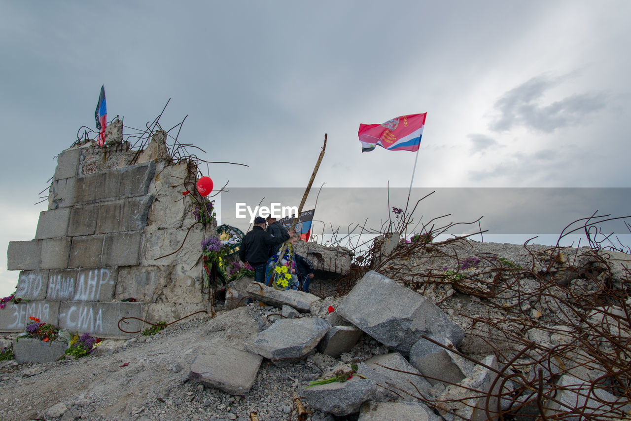 LOW ANGLE VIEW OF FLAG ON ROCK