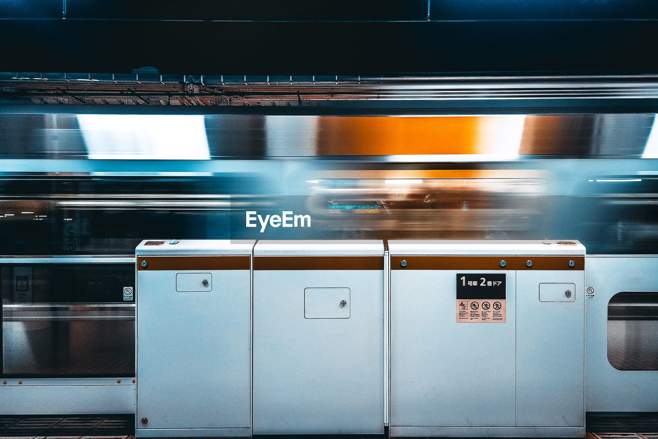 Blurred motion of train at railroad station