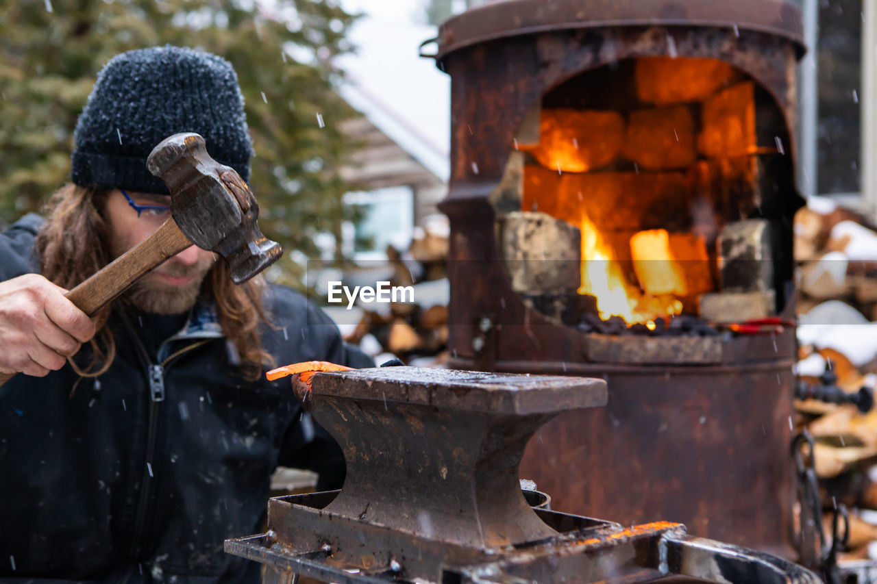 View of blacksmith working outdoors