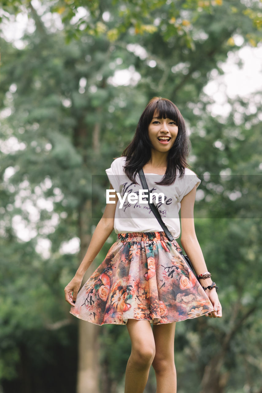 Portrait of a smiling young woman standing outdoors