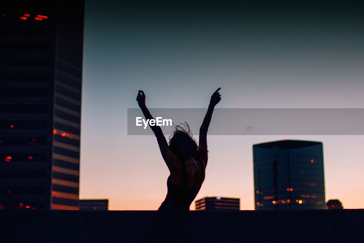 Beautiful girl enjoys sunset in the city