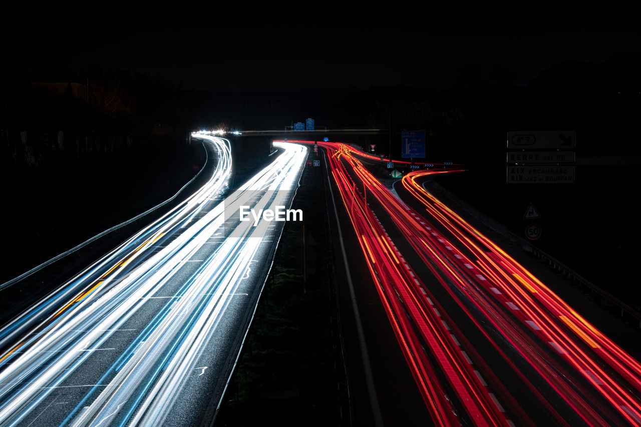 High angle view of light trails on highway at night