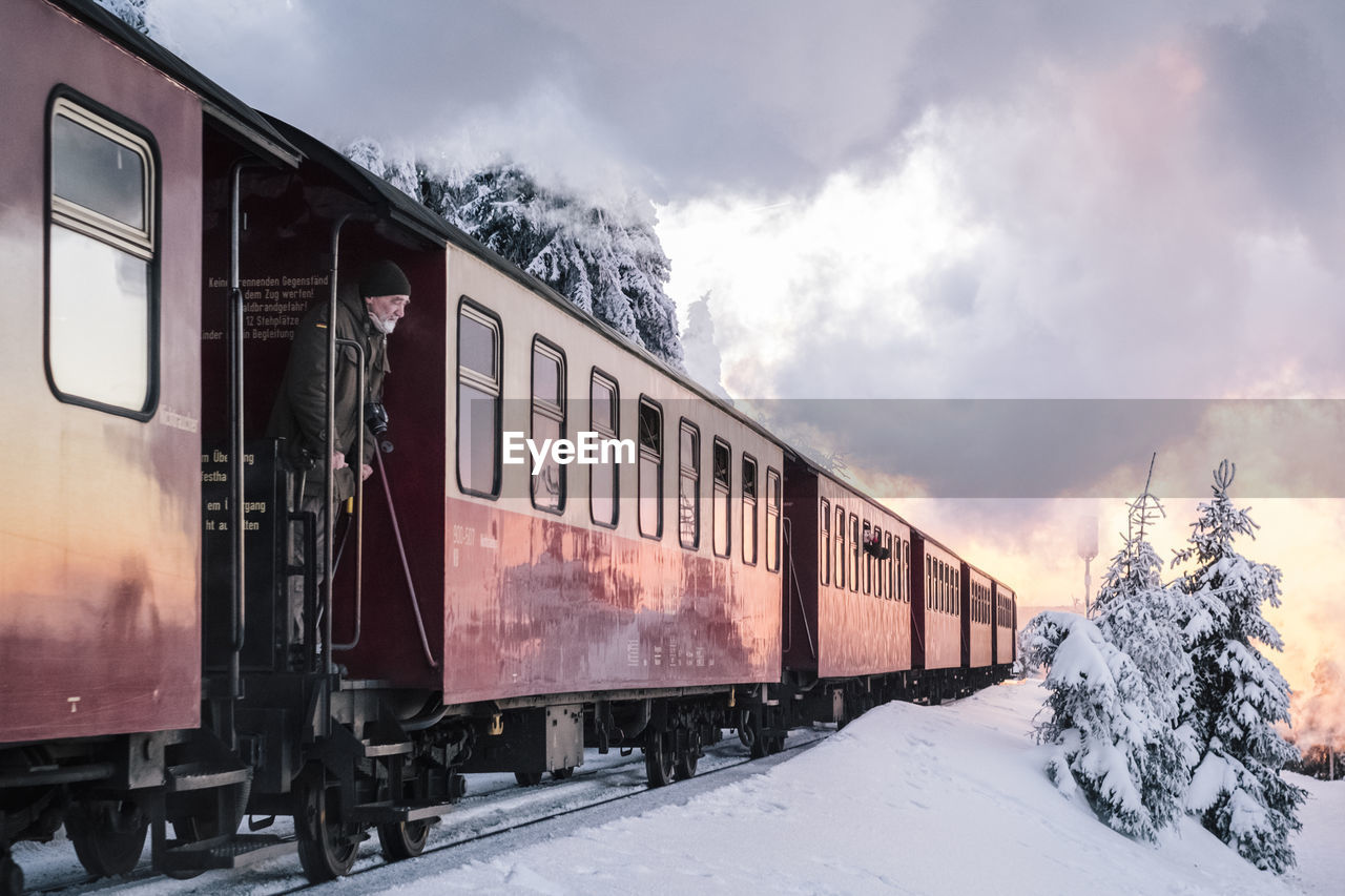 TRAIN ON RAILROAD TRACKS AGAINST SKY