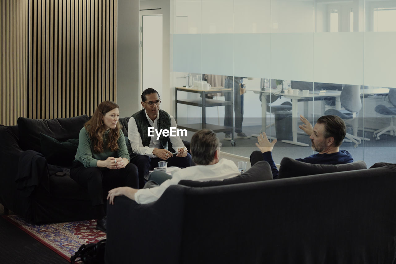 Group of business people having meeting in lobby