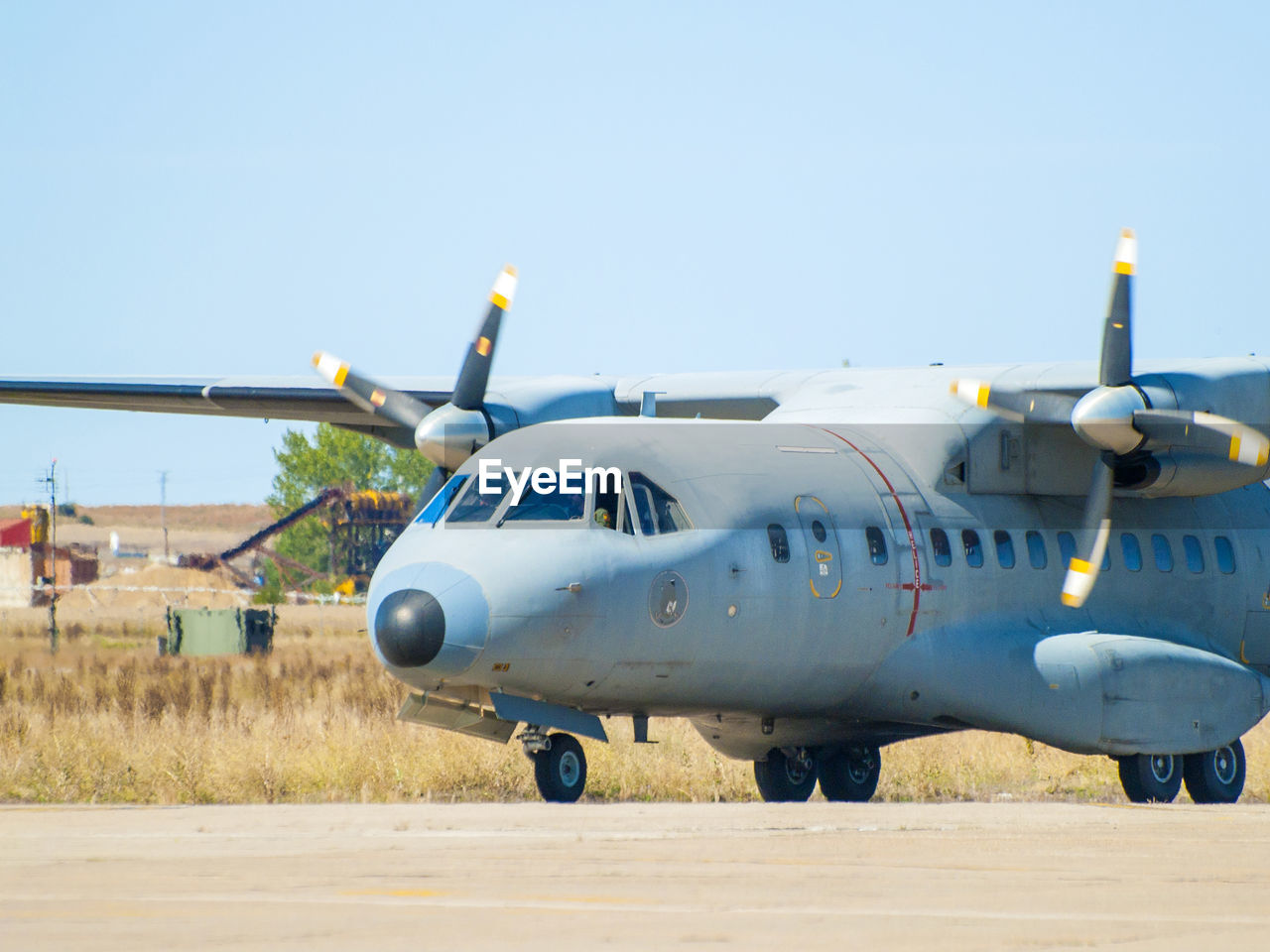 AIRPLANE ON RUNWAY AGAINST SKY