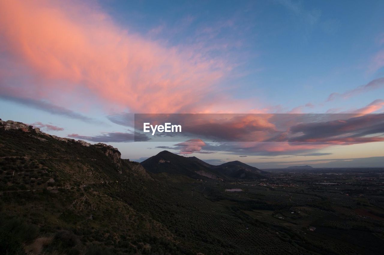 Scenic view of mountains against sky at sunset