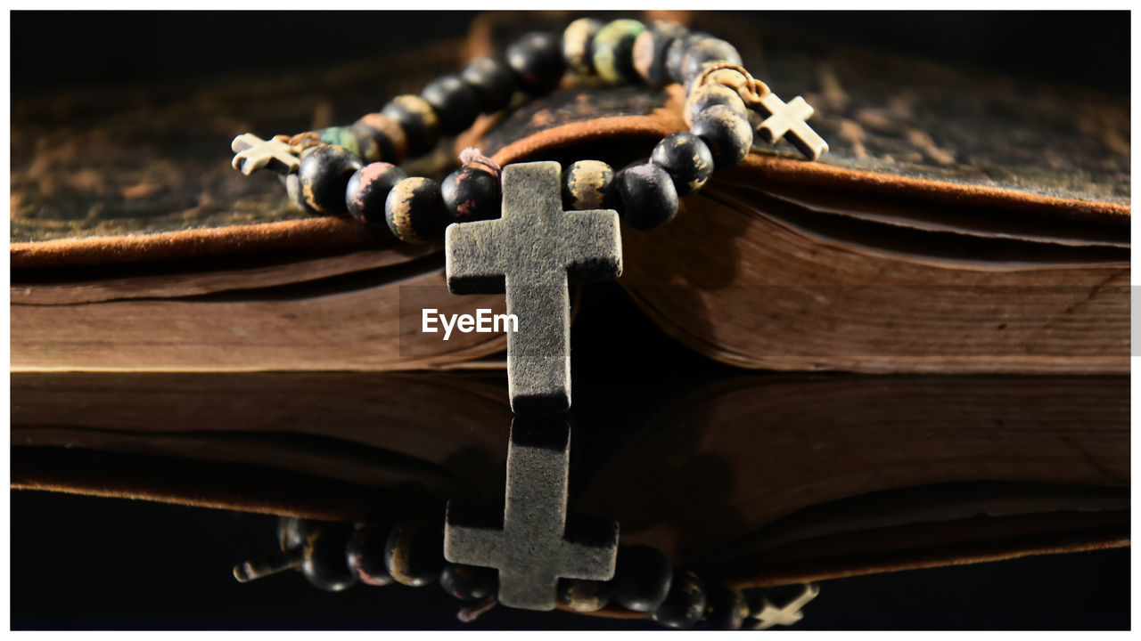 Close-up of crucifix on bible