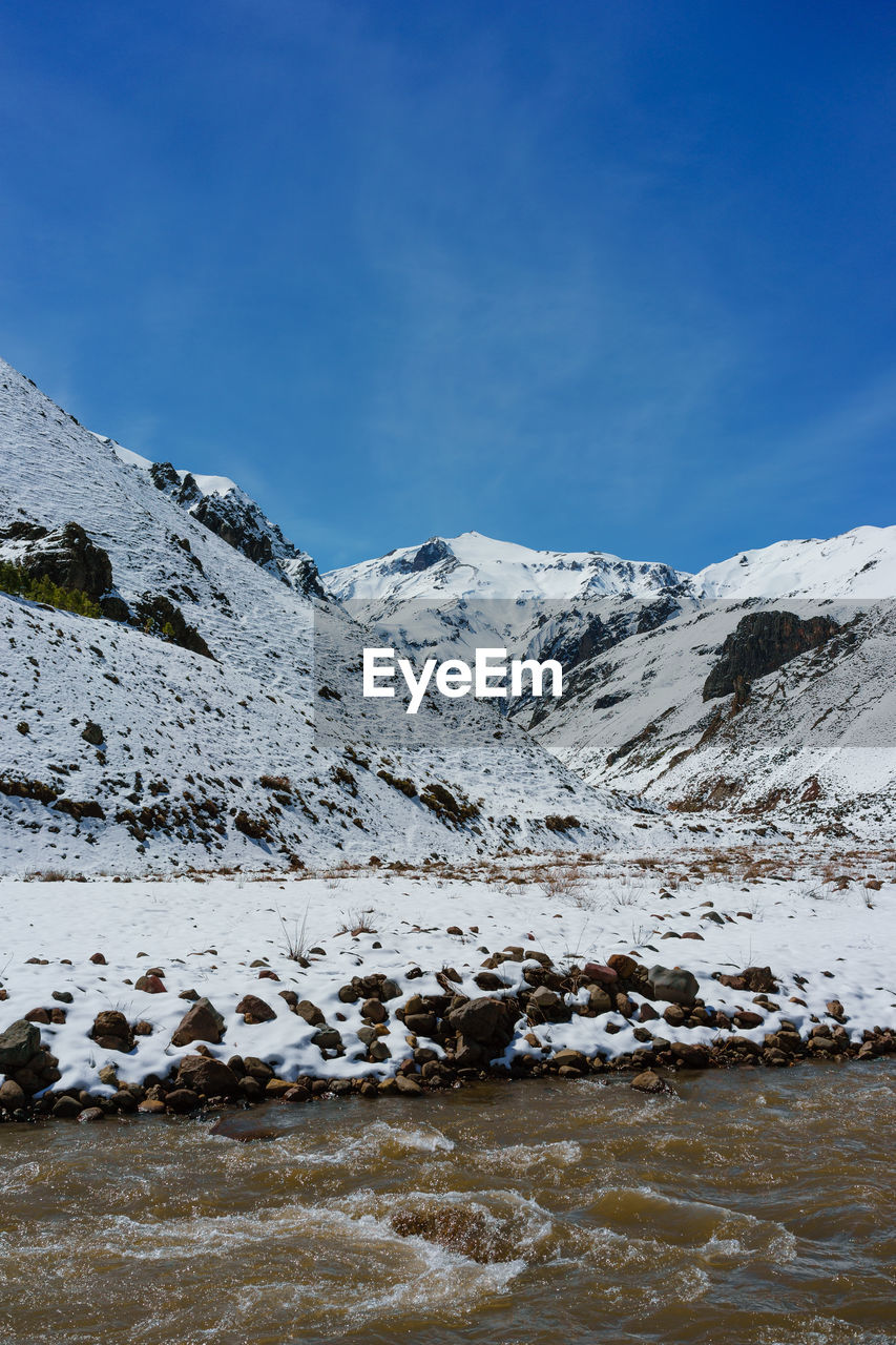 SNOW COVERED MOUNTAIN AGAINST BLUE SKY