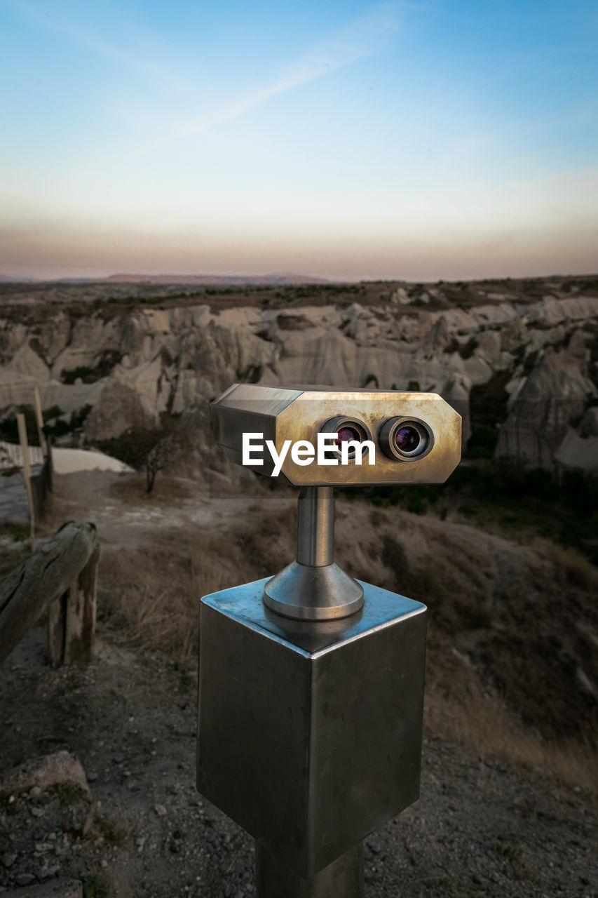 Close-up of coin-operated binoculars against sky