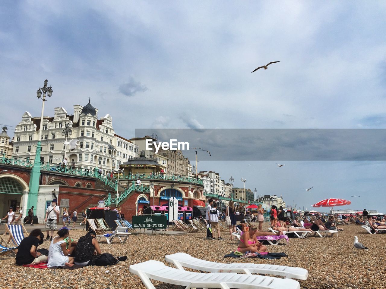 PEOPLE ON BEACH AGAINST SKY