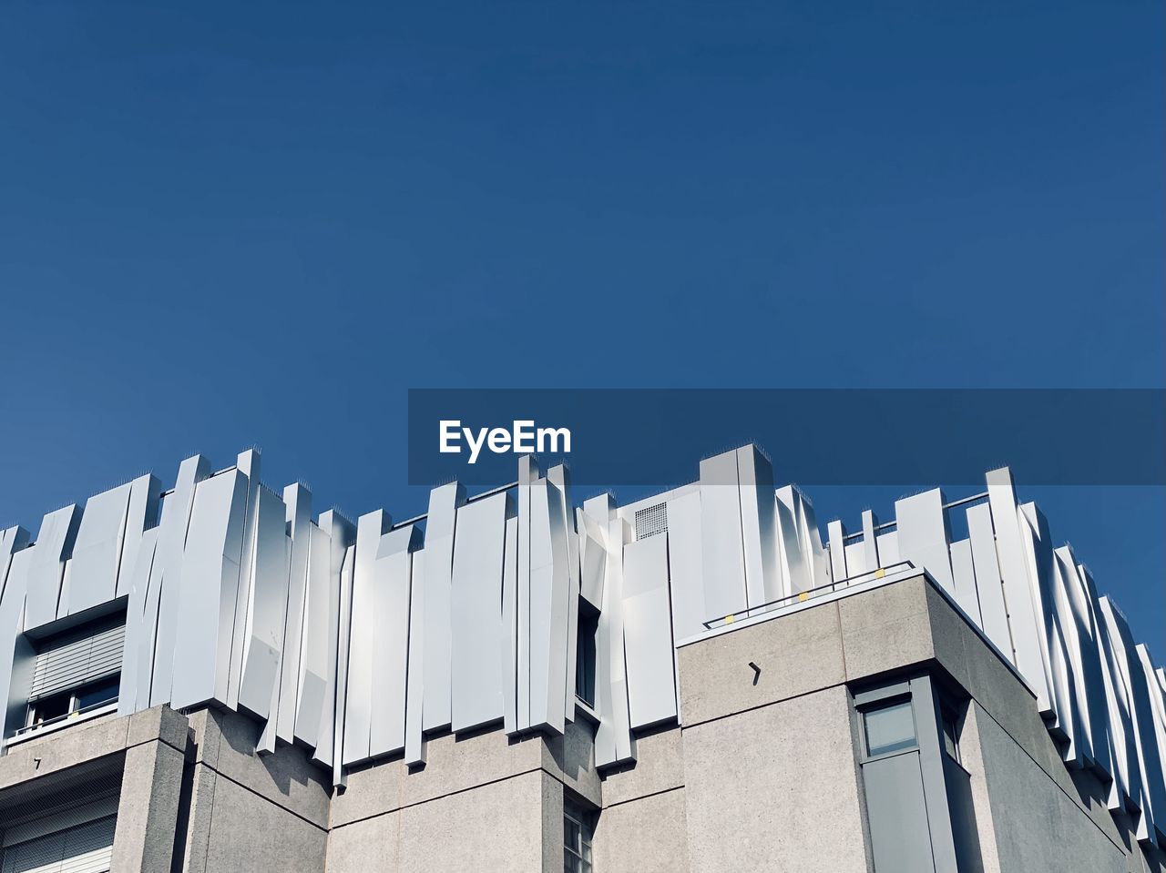 Low angle view of building against clear blue sky