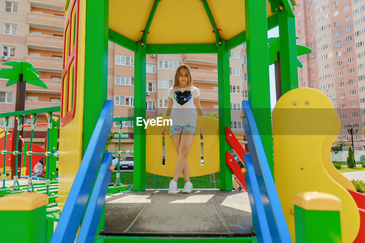 Full length portrait of girl standing in playground