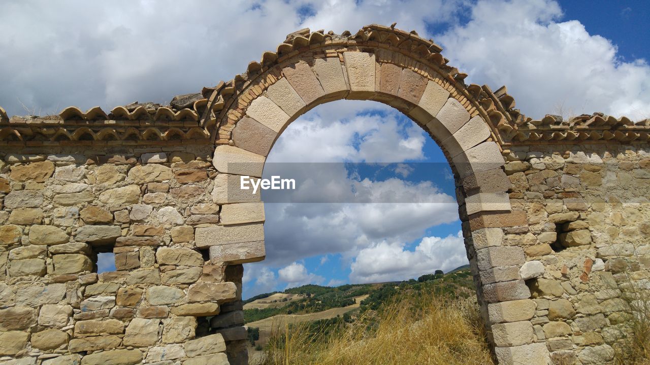 Low angle view of old ruins against sky