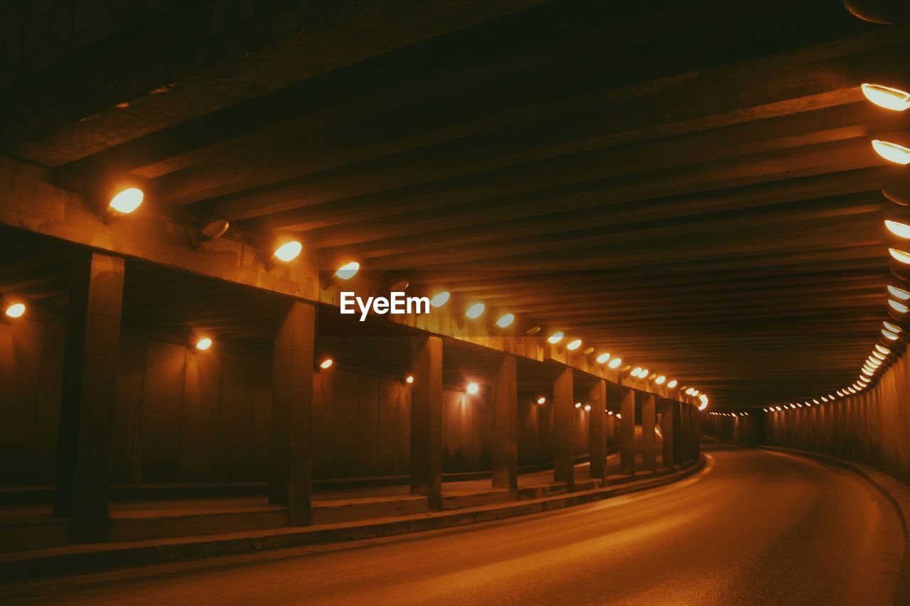 Empty illuminated road in tunnel