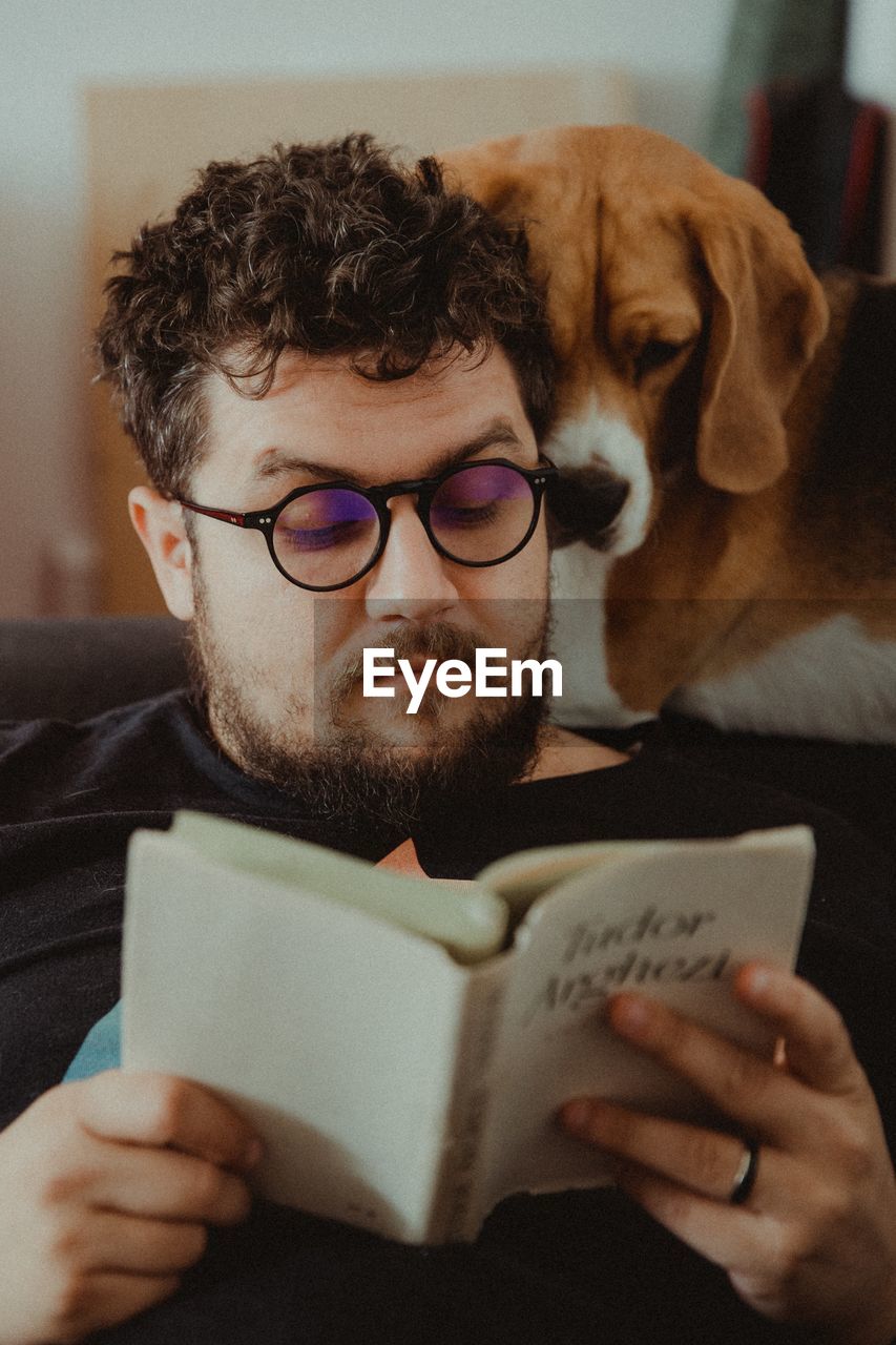 MID ADULT MAN WITH EYEGLASSES AT HOME