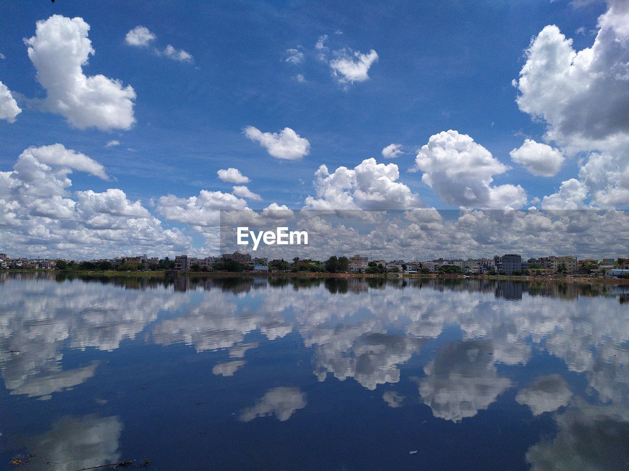 reflection, water, cloud, sky, lake, scenics - nature, nature, beauty in nature, tranquility, environment, landscape, blue, no people, tranquil scene, horizon, day, outdoors, body of water, travel destinations, travel, lagoon, non-urban scene, idyllic, shore, reservoir, standing water, land, sunlight, tree, mountain, morning