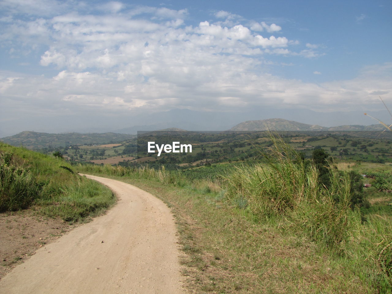 DIRT ROAD PASSING THROUGH LANDSCAPE