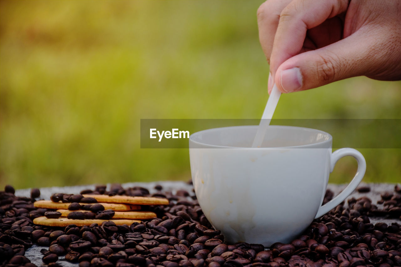 Close-up of hand holding coffee cup