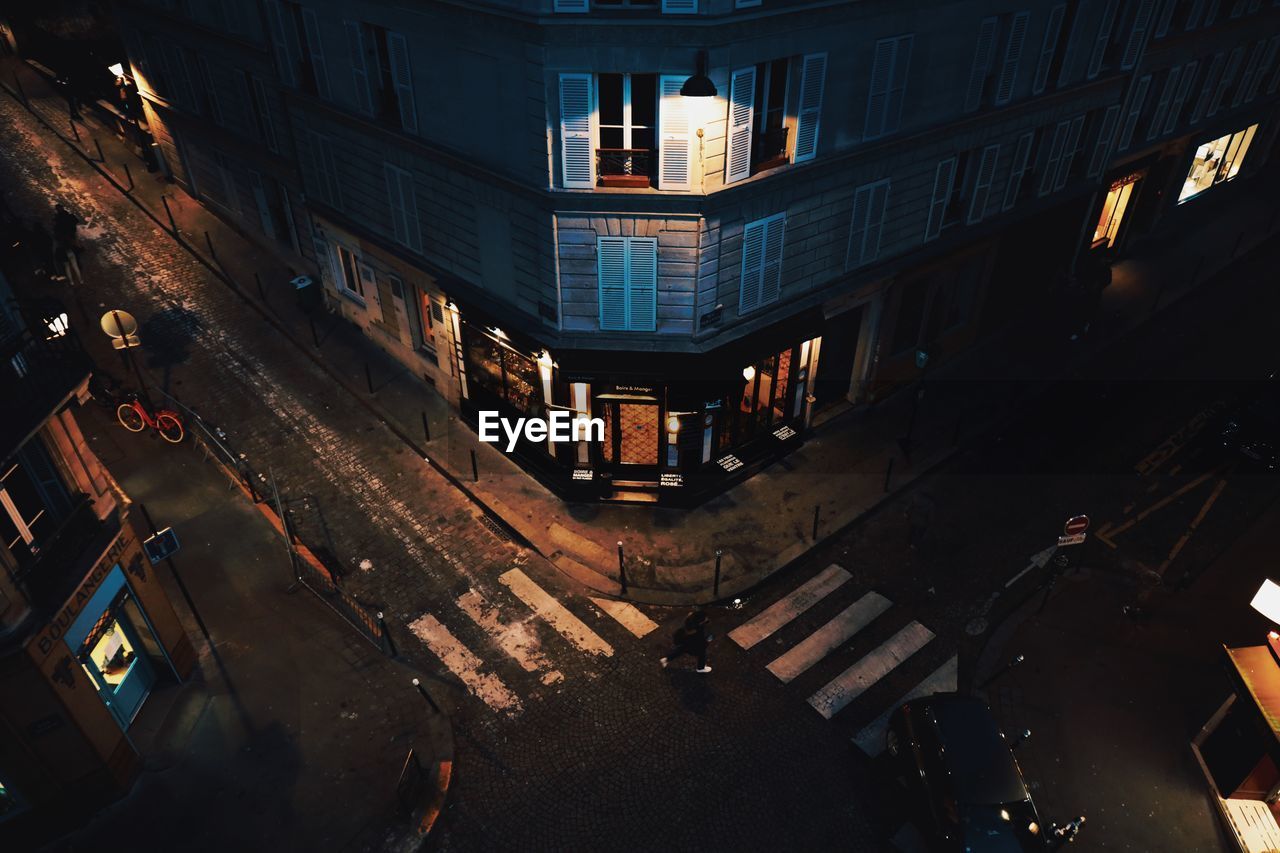 High angle view of illuminated street amidst buildings in city