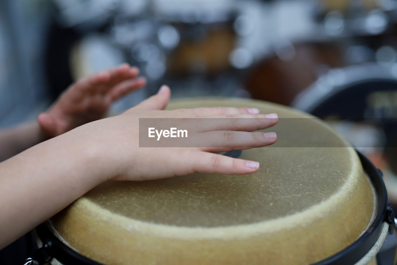 Close-up of hands playing drum 