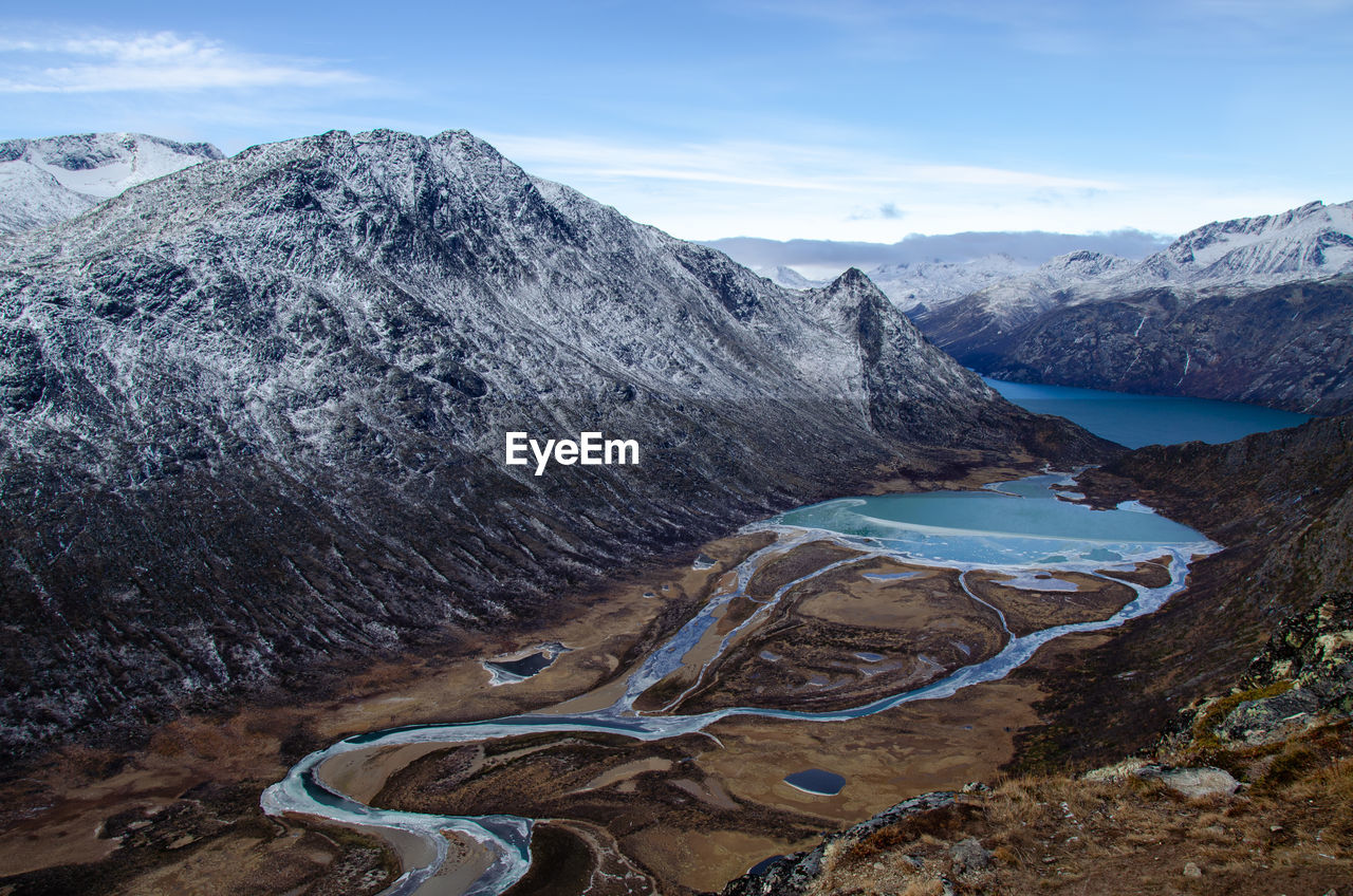 high angle view of snowcapped mountains against sky