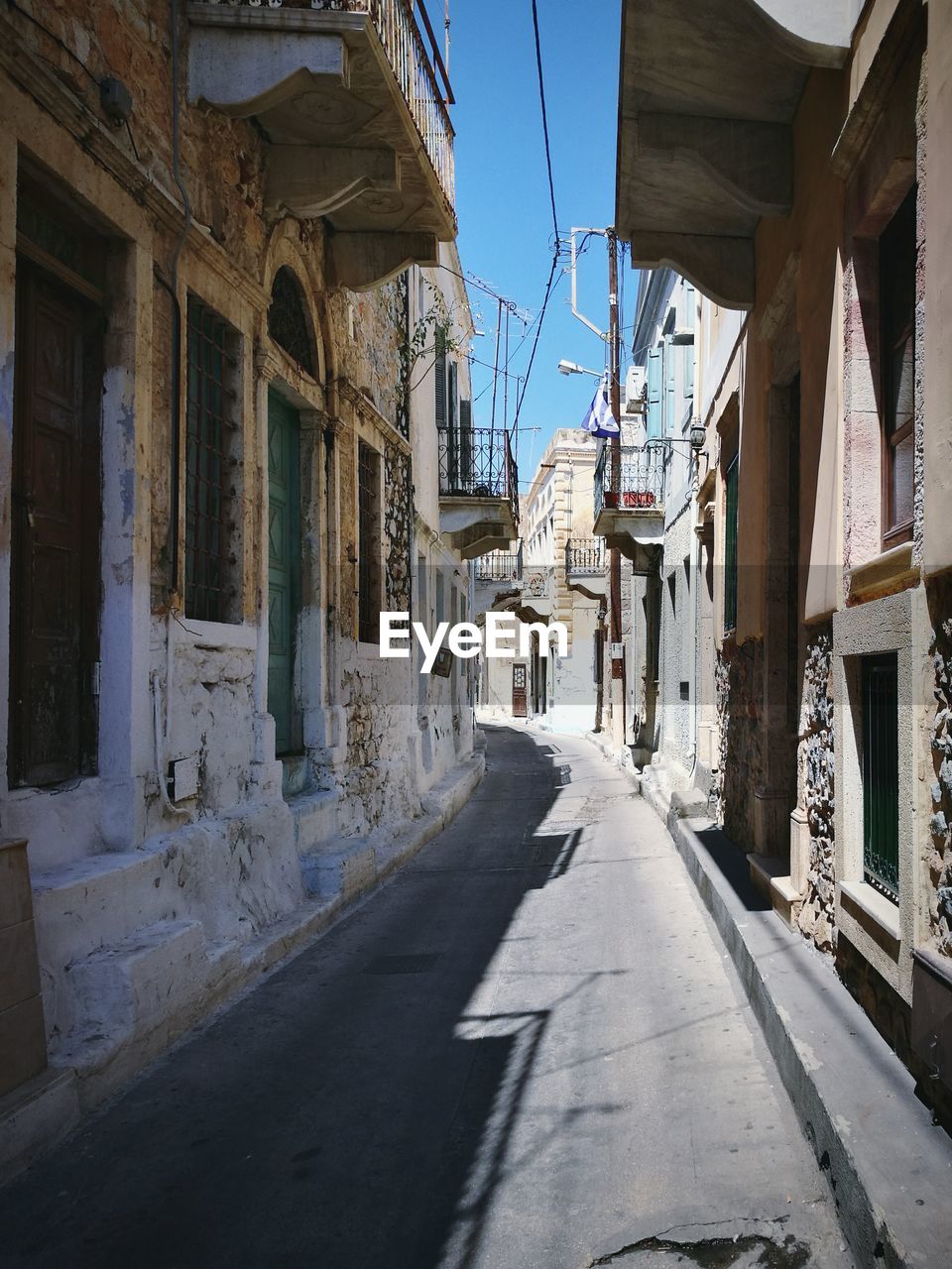 Narrow street leading towards buildings