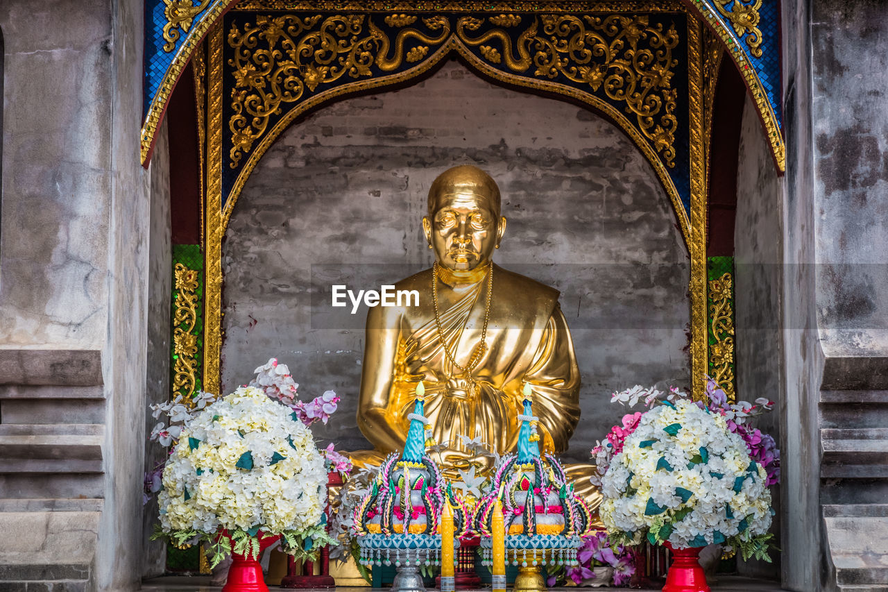 The golden statue of monk at wat den salee sri muang gan or wat ban den, temple in north of thailand