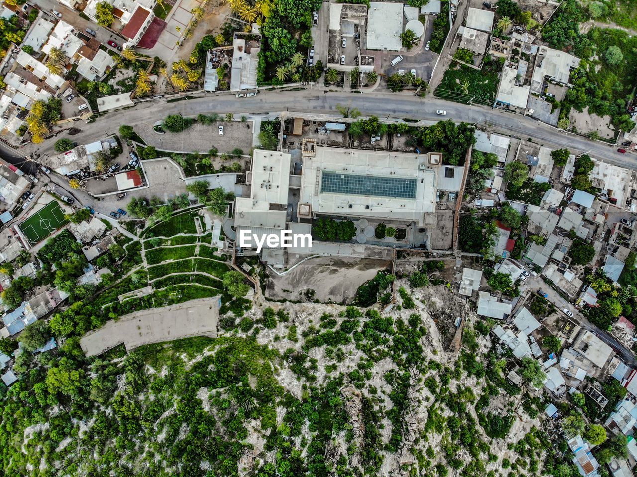 HIGH ANGLE VIEW OF STREET AMIDST BUILDINGS